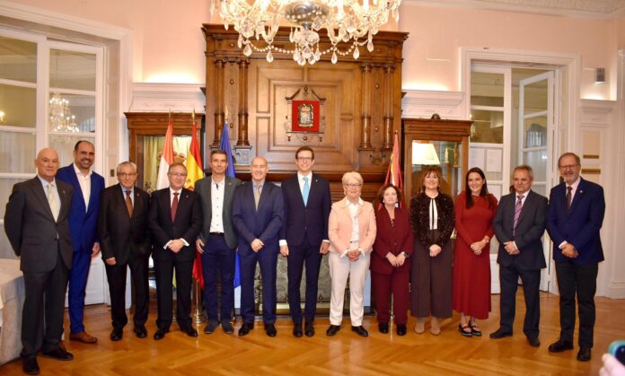 Los premiados de San Millán 2025 con la Junta Directiva del Centro Riojano con las banderas de fondo.
